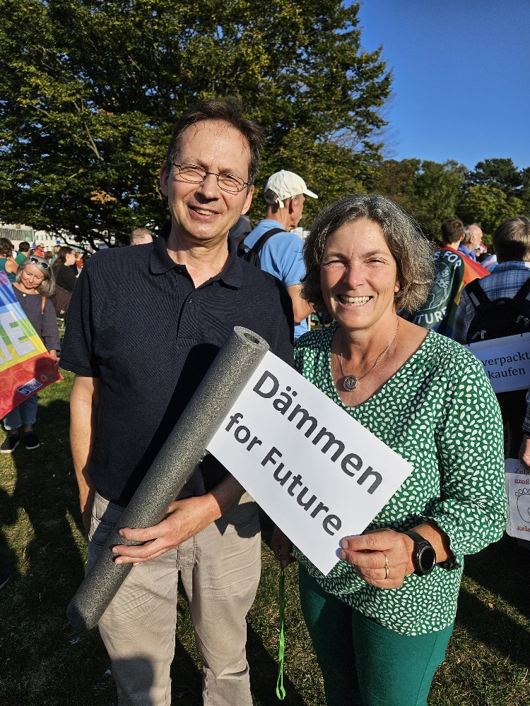 Kerstin Celina und grünes Mitglied mit dem Schild "Dämmen for Future"